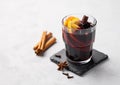 Mulled wine with orange, apple and cinnamon in glass on a light background. The concept of a traditional winter hot drink with Royalty Free Stock Photo