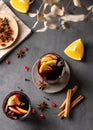 Mulled wine with orange, apple and cinnamon in glasses on a dark background. The concept of a traditional winter hot drink with Royalty Free Stock Photo