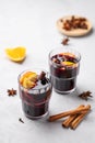 Mulled wine with orange, apple and cinnamon in glasses on a light background. The concept of a traditional winter hot drink Royalty Free Stock Photo