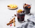 Mulled wine with orange, apple and cinnamon in glasses on a light background. The concept of a traditional winter hot drink Royalty Free Stock Photo