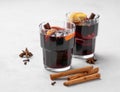 Mulled wine with orange, apple and cinnamon in glasses on a light background. The concept of a traditional winter hot drink with Royalty Free Stock Photo