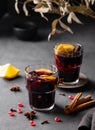 Mulled wine with orange, apple, pomegranate and cinnamon in glasses on a dark background. The concept of a traditional winter hot Royalty Free Stock Photo