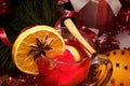 Mulled wine with orange, cloves, anise, gifts on Christmas tree.