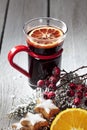 Mulled wine with orange slice cinnamon stars cinnamon sticks rose hips on wooden background