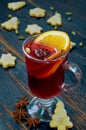 Mulled wine with orange slice and winter spices - cinnamon, cardamom and anise stars on the black wooden background Royalty Free Stock Photo