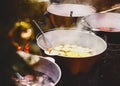 Mulled wine with oranges in large vats on Christmas market. New year and Christmas celebration concept, traditional drink Royalty Free Stock Photo