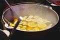 Mulled wine with oranges in large vats on Christmas market. New year and Christmas celebration concept, traditional drink Royalty Free Stock Photo