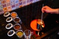 Mulled wine preparation, a metal kettle stands on the stove, the hand stirs