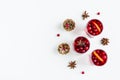 Mulled wine in small glasses with cranberries, anise and oranges. White background, top view