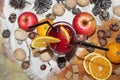 Mulled wine with spices and fruit on wooden background.Top view