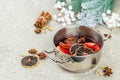 Mulled wine with spices in a pot with traditional Christmas decor. Hot beverage, festive background Royalty Free Stock Photo