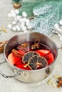 Mulled wine with spices in a pot with traditional Christmas decor. Hot beverage, festive background Royalty Free Stock Photo