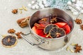 Mulled wine with spices in a pot with traditional Christmas decor. Hot beverage, festive background Royalty Free Stock Photo