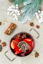 Mulled wine with spices in a pot with traditional Christmas decor. Hot beverage, festive background Royalty Free Stock Photo