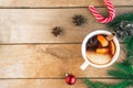 Mulled wine. Traditional Christmas and winter drink with red wine, citrus and spices and Christmas decorations on wooden backgroun