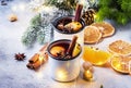 Mulled wine in white metal mugs with cinnamon, spices and orange with fir tree and christmas lights - traditional drink on winter Royalty Free Stock Photo