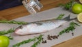 Mullet fish with marinade. Pepper the dish with pepper grinder