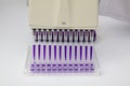 Multi channel pipette loading biological samples in microplate for test in the laboratory / Multichannel pipette load samples in Royalty Free Stock Photo