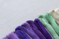 Multi-color embroidery threads on white canvas. Place for text. Macro Royalty Free Stock Photo