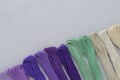 Multi-color embroidery threads on white canvas. Place for text Royalty Free Stock Photo
