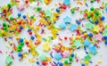 Multi-color festive background of a scattering of sugar candy sprinkles for cupcakes and other pastries in form of stars, sticks Royalty Free Stock Photo