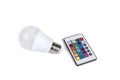 Multi color led bulb with a remote control  on a white background Royalty Free Stock Photo