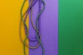 Multi color Mardi Gras beads on paper background. Top view Royalty Free Stock Photo