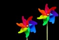 Pair of multi color pinwheels on black background Royalty Free Stock Photo