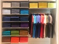 Colorful polo shirts on hanger and shelves in shopping mall Royalty Free Stock Photo