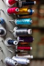 Multi color small spools of sewing thread stacks on large cylinder display Royalty Free Stock Photo