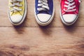 Multi Color sneakers on wood background