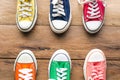 Multi Color sneakers on wood background