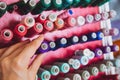 Multi color Spools of thread needlework, sewing, tailoring and tailoring concept woman hand Royalty Free Stock Photo