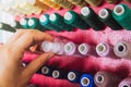 Multi color Spools of thread needlework, sewing, tailoring and tailoring concept woman hand Royalty Free Stock Photo