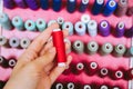 Multi color Spools of thread needlework, sewing, tailoring and tailoring concept woman hand Royalty Free Stock Photo