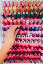 Multi color Spools of thread needlework, sewing, tailoring and tailoring concept woman hand Royalty Free Stock Photo