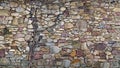 Multi color stacked stone wall with old vine. Royalty Free Stock Photo