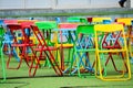 Multi-color steel chair set on green plastic grass In the playground Royalty Free Stock Photo