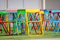 Multi-color steel chair set on green plastic grass In the playground Royalty Free Stock Photo