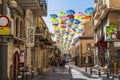 Multi-color umbrella display hanging high over a street