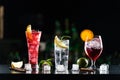 Multi-colored alcoholic cocktails with citrus in glasses of different shapes on the bar. Royalty Free Stock Photo