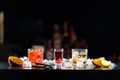 Multi-colored alcoholic cocktails with citrus in glasses of different shapes on the bar. Royalty Free Stock Photo