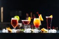 Multi-colored alcoholic cocktails with citrus in glasses of different shapes on the bar. Royalty Free Stock Photo