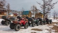 Multi-colored ATVs lined up in two rows