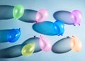 Multi-colored balloons on a blue background with shadows Royalty Free Stock Photo
