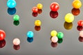 Multi colored balls of chewing gum on a gray background with reflection