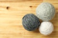 Multi colored balls of yarn on light wooden background Royalty Free Stock Photo