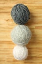 Multi colored balls of yarn on light wooden background Royalty Free Stock Photo