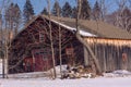 Multi colored barn in snowy field on sunny New England winter day Royalty Free Stock Photo