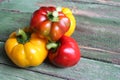 Multi-colored bell peppers on the background of boards Royalty Free Stock Photo